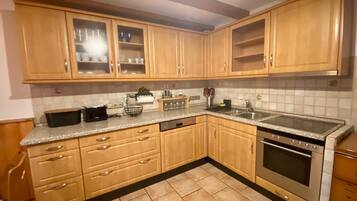 Fridge, stovetop, dishwasher, coffee/tea maker