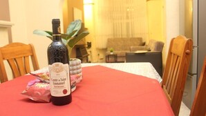 A dining table with a bottle of wine, a decorative plant, and a bag of snacks. - mater dei <br>suite near royal Liverpool hospital (Liverpool)
