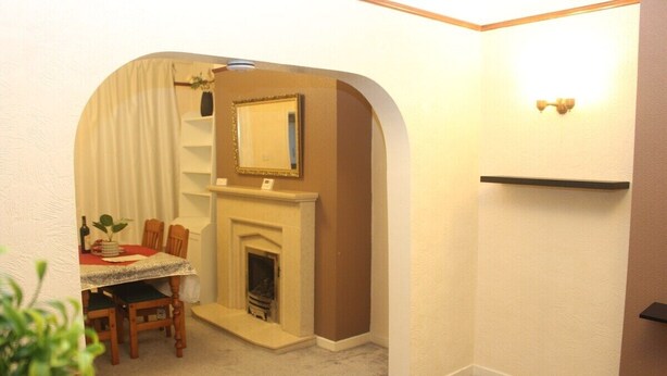 A cozy room with a fireplace, a dining table with chairs, and a small seating area. - mater dei <br>suite near royal Liverpool hospital (Liverpool)