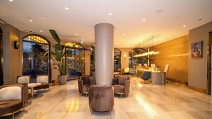 A modern lobby with a central column, seating area, and a reception desk. - Rayelin Hotel Old Town  (Istanbul)