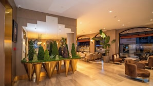 A modern lobby with a reception desk, seating area, and a staircase. - Rayelin Hotel Old Town  (Istanbul)