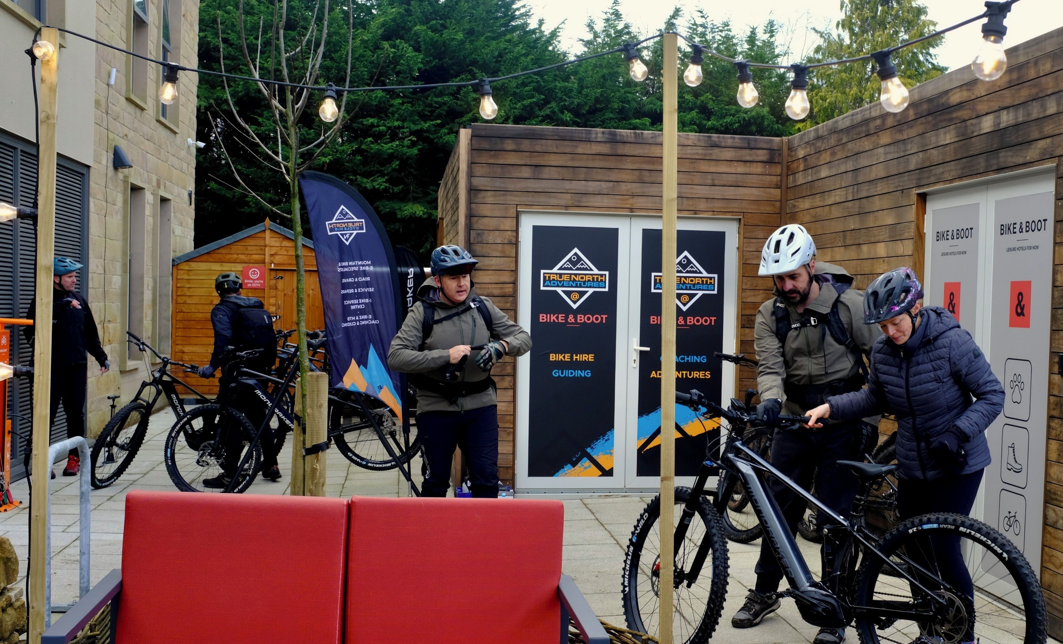 A wooden building with signs for 'True North Adventures' and 'Bike & Boot' services.