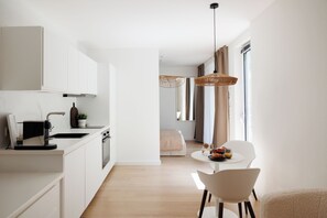 Apartment, Garden View | Living area | 32-inch Smart TV with cable channels, Netflix, heated floors - BOHO City Suites Augarten (Vienna)