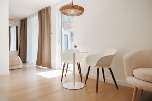 Apartment, Garden View | Living area | 32-inch Smart TV with cable channels, Netflix, heated floors - BOHO City Suites Augarten (Vienna)