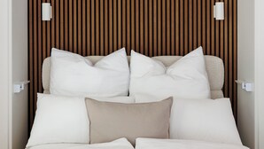 A modern bedroom with a bed, white bedding, and a wooden slat wall. - BOHO City Suites Augarten (Vienna)