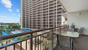 A high-rise hotel with multiple balconies, a pool area, and outdoor seating. - Shoreline Sunsets: 2BR Condo with Modern Comforts (North Myrtle Beach)