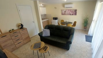 Classic Apartment, Courtyard View | Living area | 100-cm flat-screen TV with cable channels