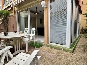 Enjoy al fresco dining on the patio, surrounded by lush greenery and a modern design.