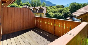 Enjoy breathtaking views of the surrounding mountains from this balcony with a traditional village backdrop.
