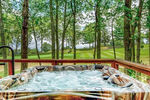 A hot tub with a view of a golf course. - Love to Beech (Banner Elk)