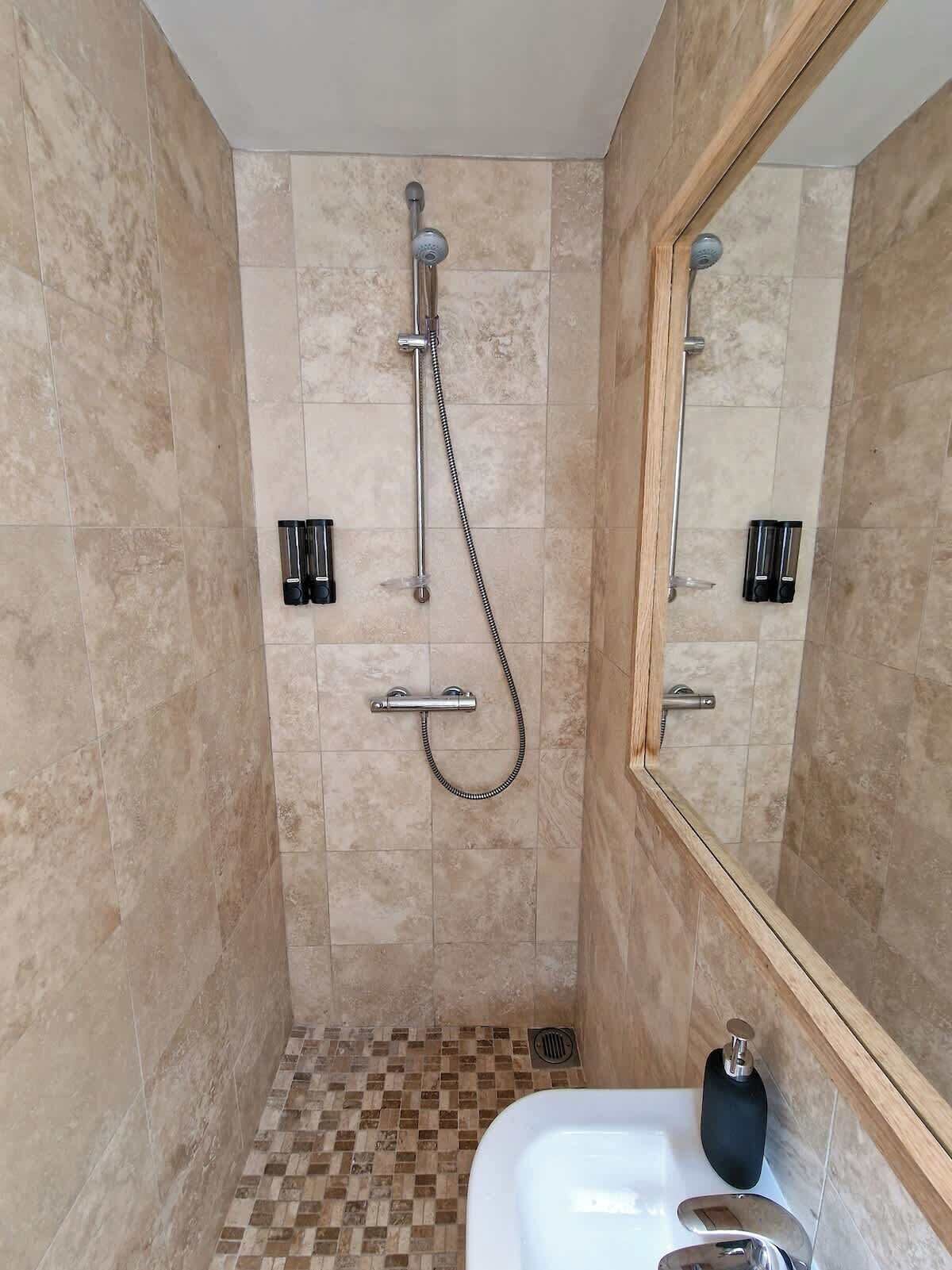 Shower, hair dryer, towels, shampoo