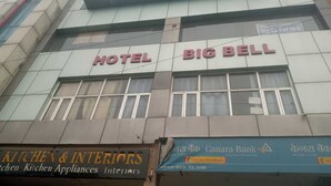 Een hotel genaamd "HOTEL BIG BELL" met een bordje met daarop "KITCHEN & INTERIORS".
