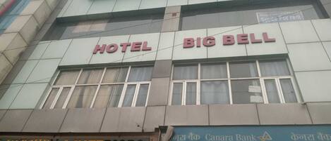 A hotel named "HOTEL BIG BELL" with a sign for "KITCHEN & INTERIORS" below it.