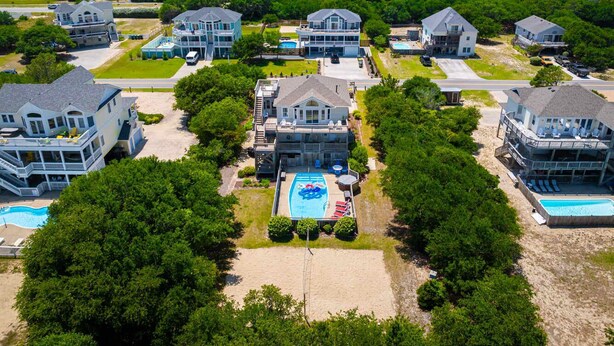 A residential area with multiple houses, a central swimming pool, and a beach. - Private pool/spa, rooftop deck, 5min walk to beach (Corolla)