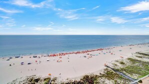 A beach with umbrellas and people. - Windward Pointe 1405 by Liquid Life (Orange Beach)