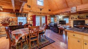 A cozy cabin interior with a dining area, a living room, and a kitchen. - Bridgepoint Cabin (Vilas)