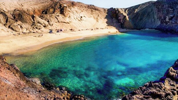 A coastal landscape with clear turquoise waters, rocky cliffs, and a sandy beach. - Villa Buena Vista Bocaina (Yaiza)
