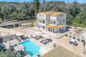 A two-story house with a swimming pool, outdoor seating, and a garden. - Villa Elegio (Corfu)