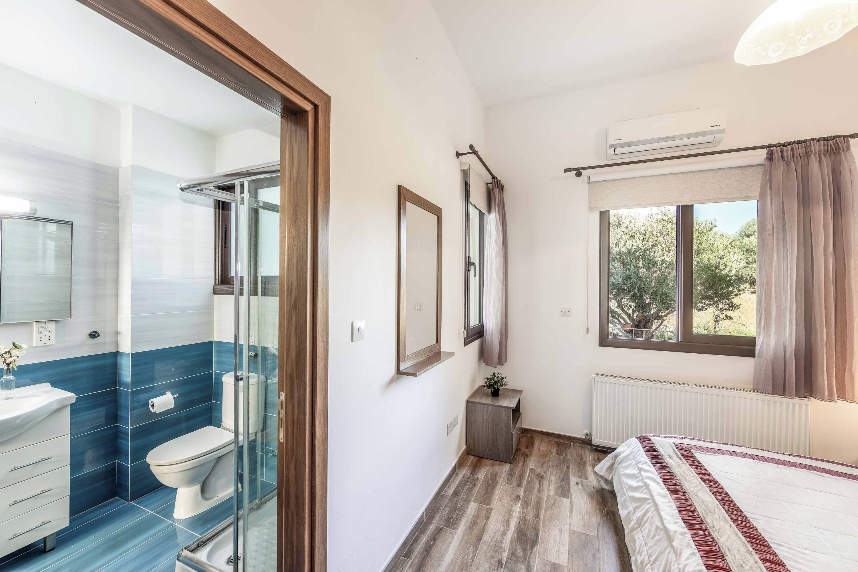 A modern bathroom with a glass shower enclosure, a toilet, and a sink.