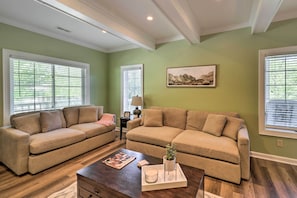 A living room with two beige sofas, a coffee table with a tray, and a painting on the wall. - Lillys Mountain Escape (Banner Elk)