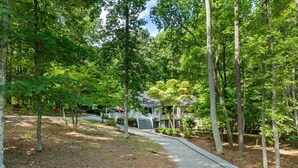 A pathway leading to a house surrounded by trees. - Lake Relaxin` | Fabulous Flat Lot | Great Water View! (Henrico)