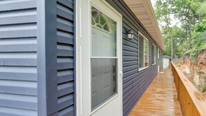 A wooden deck with a door and windows on a house. - Kayaks, Boat Slip, Game Room, Calm Cove, Great loc (Osage Beach)