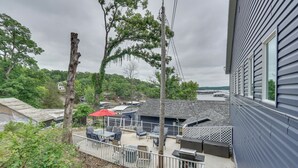 A residential property with a patio area, outdoor furniture, and a view of a body of water. - Kayaks, Boat Slip, Game Room, Calm Cove, Great loc (Osage Beach)