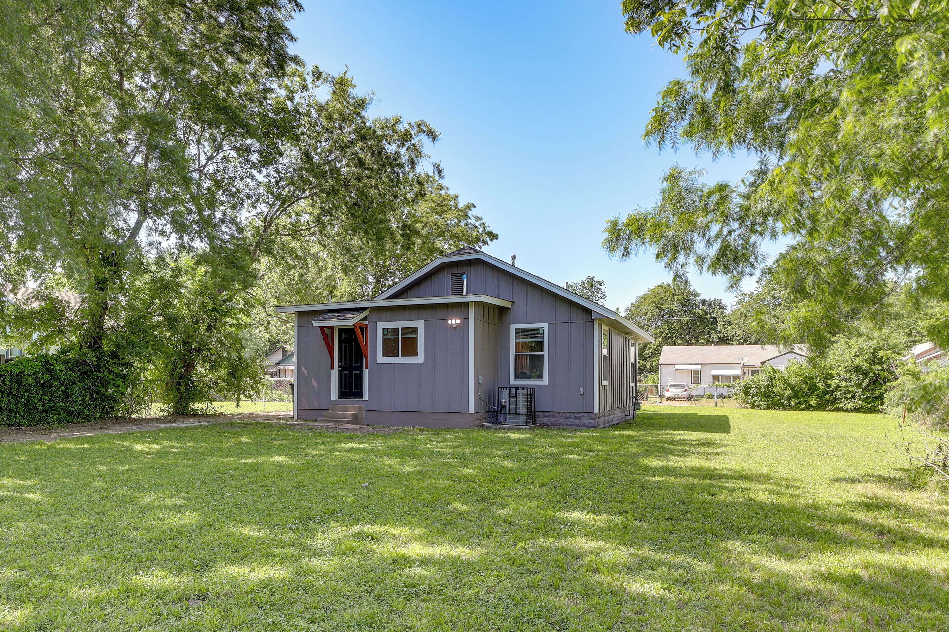 A single-story house with a front porch, a small front yard, and a garage.