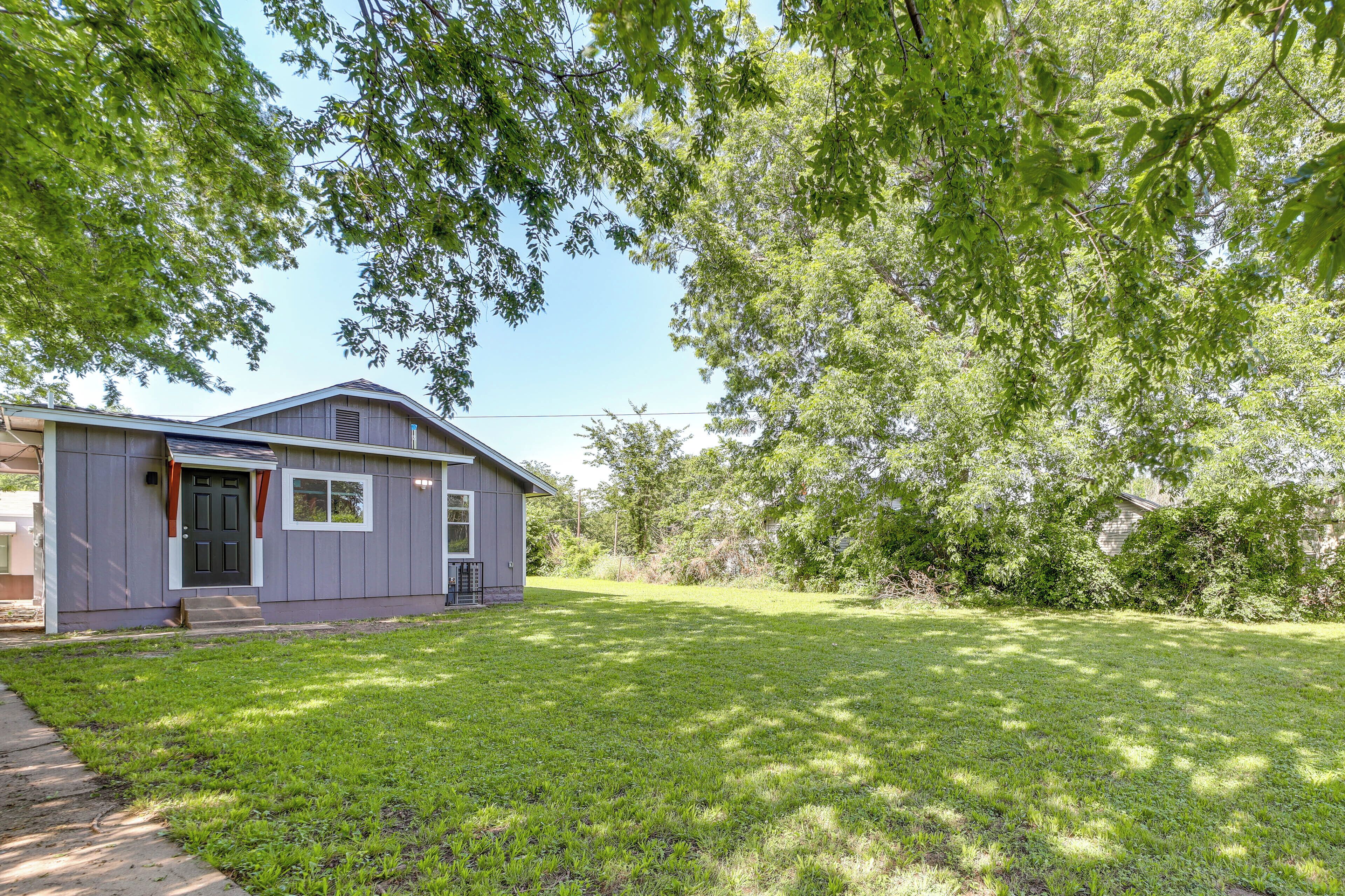 A single-story house with a front door, a small porch, and a well-maintained lawn.