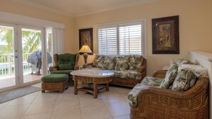 A living room with a sofa, armchairs, a coffee table, and a lamp. - Large home with a private pool! (Key Colony Beach)