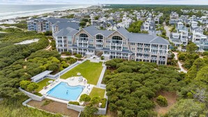A large, multi-story hotel with a pool and beachfront view. - Dune Trails | Beach Access | Shared Pool (Watersound)