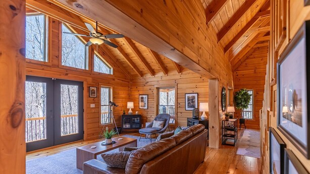 A log cabin interior with a large wooden ceiling, a sofa, a desk, and a telescope. - The Mountainbrier (Banner Elk)