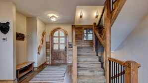 A wooden staircase with a wooden railing and a bench at the bottom. - Triple Bear Lodge at Eagles Nest (Banner Elk)