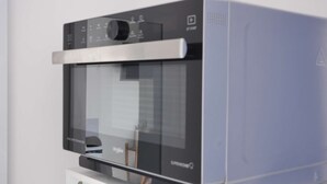 A modern kitchen with a built-in oven and microwave. - Oparadi "Le Nid" Avec sa Terrasse (Wimereux)