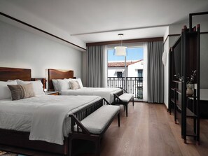 A hotel room with two beds, a balcony, and a view of the building. - Sanctity Hotel Rancho Cucamonga, Tapestry Collection Hilton (Rancho Cucamonga)