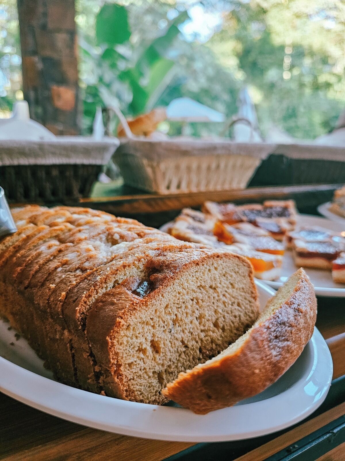 A loaf of bread on a plate with a rustic background.