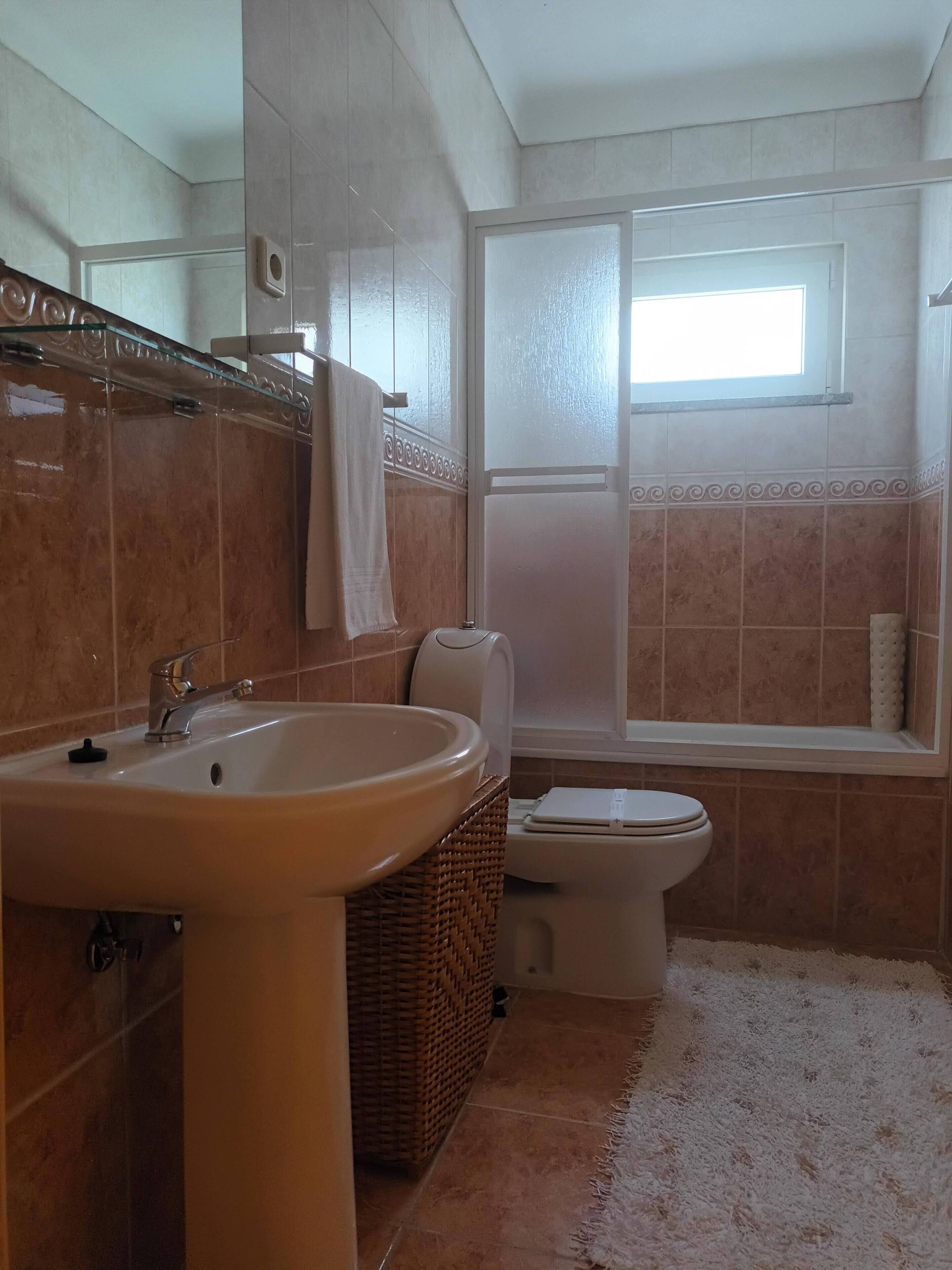 A bathroom with a large sink, toilet, and bathtub.