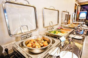 A buffet setup with multiple food stations and a bowl of nuts. - Westcare Hotel (Century City New Convention and Exhibition Center Tianfu 3rd Street Store) (Chengdu)