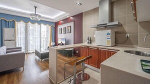 A modern kitchen with a central island, wooden cabinets, and a stainless steel sink. - Westcare Hotel (Century City New Convention and Exhibition Center Tianfu 3rd Street Store) (Chengdu)