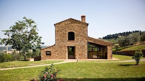 A stone house with a large glass window and a small door. - Villa Meraviglia With Pool And Ac (Poggibonsi)