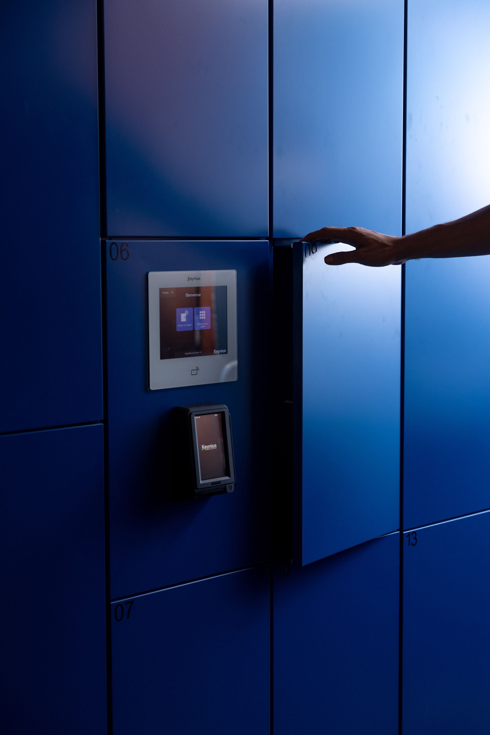 A hand interacting with a digital lock on a blue elevator door.