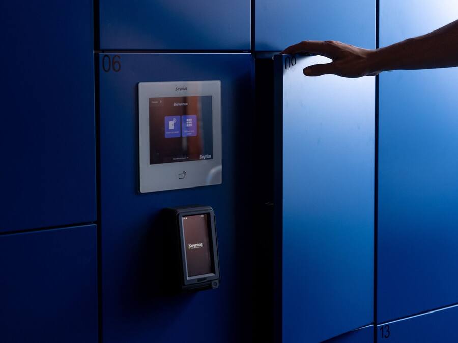 A hand interacting with a digital lock on a blue elevator door.