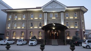 A large, historic building with a prominent entrance and multiple windows. - Hotel BEK Tashkent (Tashkent)