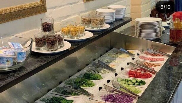 A buffet with various food options including salads, fruits, and other dishes. - Hotel BEK Tashkent (Tashkent)