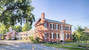 A large brick building with a prominent entrance and a covered porch area. - Black Walnut Inn (Amherst)