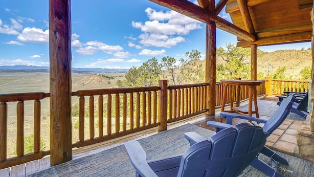 A wooden deck with chairs overlooking a scenic landscape. - 24-0089 Rustic Hartsel Getaway w/ 35-Acre Yard (Fairplay)