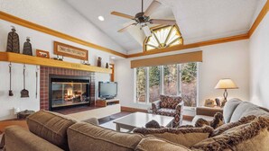 A cozy living room with a fireplace, comfortable seating, and a television. - The Charter at Beaver Creek D4105 (Beaver Creek)