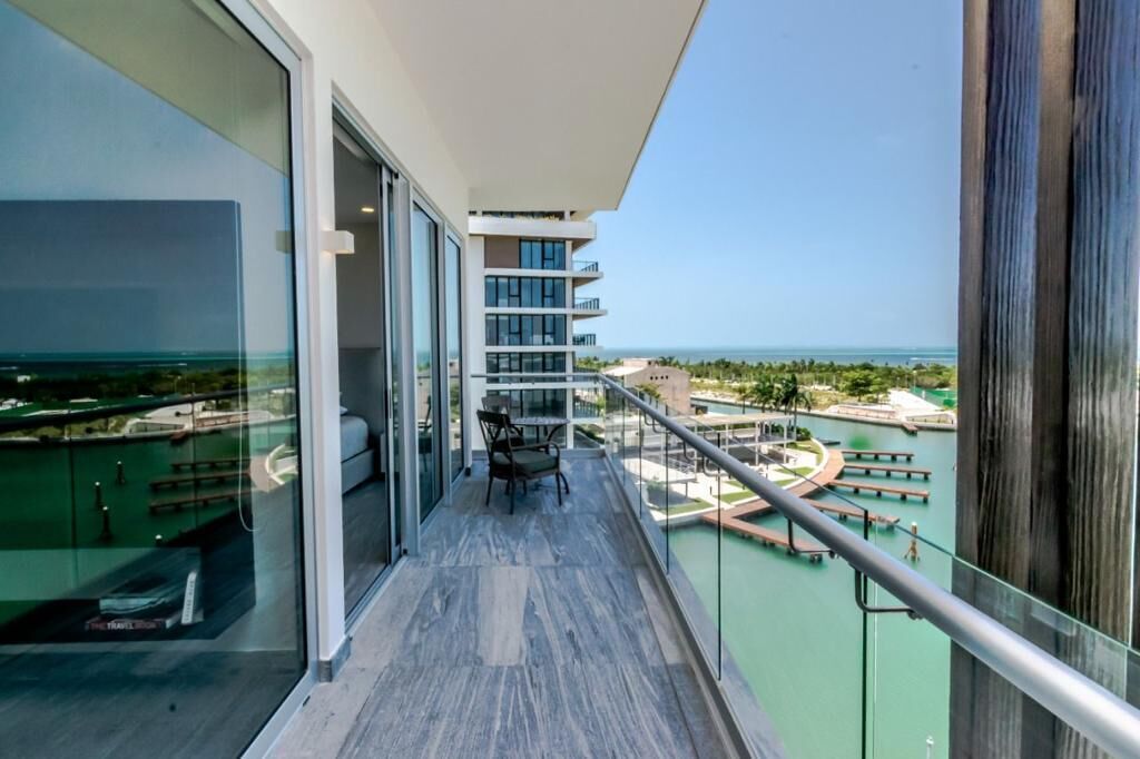 A balcony with a view of a marina and ocean.