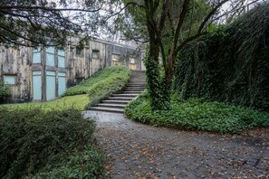 Stroll through lush gardens to a serene retreat with a welcoming entrance.