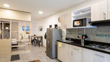 Fridge, microwave, coffee/tea maker, cookware/dishes/utensils